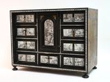 a black and white chest of drawers with pictures on it