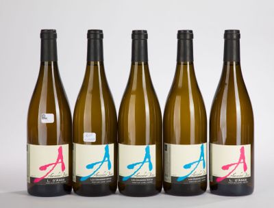 four bottles of wine are lined up on a white surface