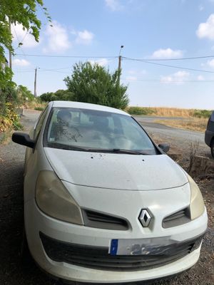 a white car that is parked on the side of the road