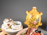 a lot of plates and bowls of food on the table