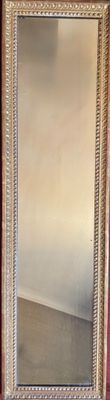 a mirror that is sitting on a table in a room