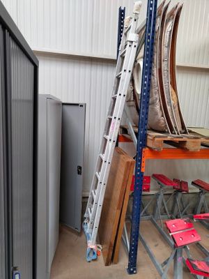 a ladder that is sitting on a shelf in a room