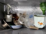 many dishes and cups inside of a microwave