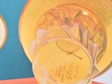 a bottle of perfume sitting on top of an orange cloth