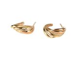 a pair of gold earrings with wavy design on them