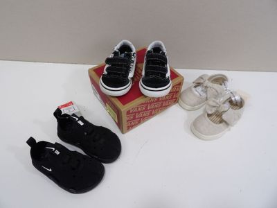 deux paires de chaussures noires et blanches et une boîte de chaussures blanches