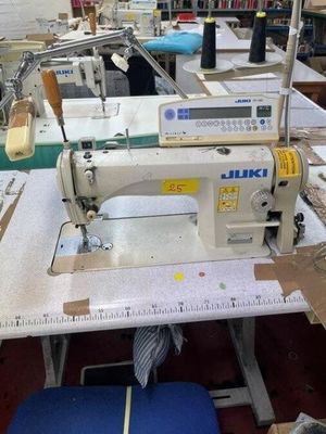 a sewing machine that is sitting on a table in a room