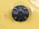 a close up of a yellow sink with a black drain
