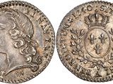 a silver coin with a crown on the front and a crown on the back