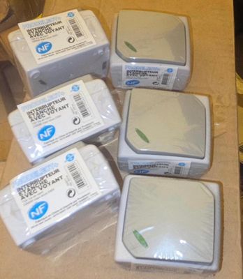 four boxes of soap sitting on top of a counter next to a cup of coffee