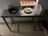 a table with a bowl and a plate on it in a kitchen