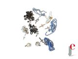many different types of jewelry on a white surface