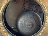 a clock that has a metal ball in the middle of it