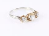 a close up of a ring with three diamonds on a white background