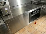 a large stainless steel kitchen with a stove and oven