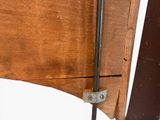 a close up of a wooden table with a metal handle on it