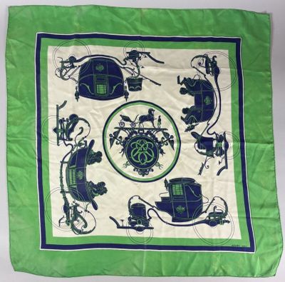 a close up of a green and white scarf with a picture of a car
