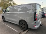 a silver van that is parked in a parking lot