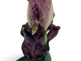 a figurine of a purple flower on a white background