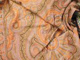 a close up picture of a scarf on a chair