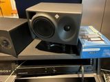 two speakers and a cd player on a table