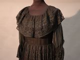 a mannequin in a dress on display in a museum