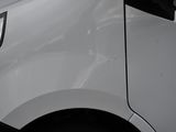 a close up of a white truck with a black stripe