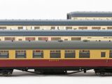 four train cars that are lined up on a white surface