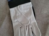 white gloves with a black wrist and a card on top of it