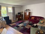 a living room with a couch, chair, coffee table and a television
