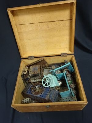 a wooden box with a toy gun inside of it