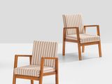 three wooden chairs with striped upholstered cushions in a white room