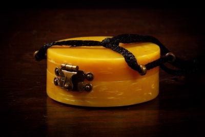 a small yellow box with a black ribbon around it