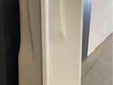 a white urinal sitting on the floor next to a wall