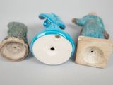 three ceramic figurines are sitting on a table next to each other