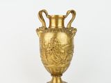 an image of a gold vase sitting on top of a white surface