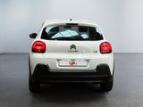 the rear of a white citrole parked in a room