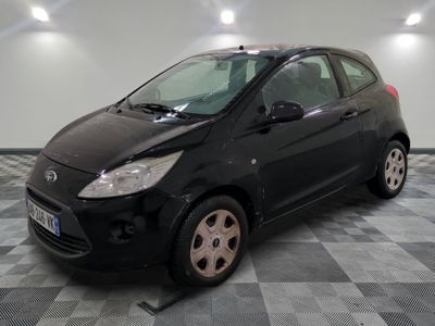 a picture of a small black car parked on a checkered floor