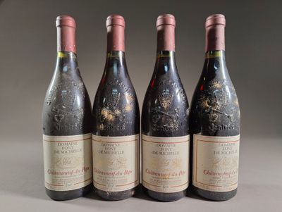 three bottles of red wine are lined up on a table