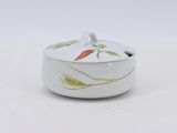 a close up of a white bowl with a lid on a white surface