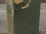 an old book sitting on top of a cement floor next to a wall