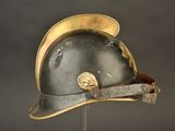 a helmet that is on a stand with a hat on it