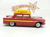 a red toy car with a sign on top of it