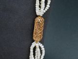 pearl necklace with a gold clasp and a gold clasp