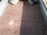 a metal bed with a tarp on top of it