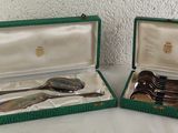 two green cases with spoons and spoons in them