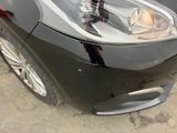 a close up of a car ' s headlight on the side of the road