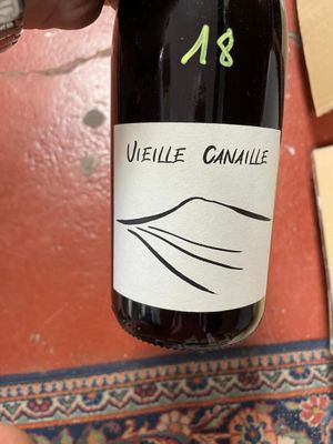 a bottle of wine that is being held by a person