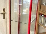 a glass display case in the corner of a room