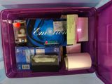a purple container filled with toilet paper and other items